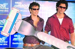 Bollywood actors Milind Soman (L) and Kunal Kapoor pose with 'Gillette MACH 3' Turbo, a new shaving razor, at its launch in New Delhi on Thursday.