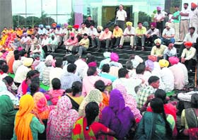 Employees of the municipal council stage a dharna outside the office in Mohali