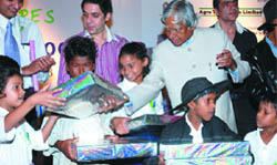 Former President A.P.J. Abdul Kalam distributes gifts to children during the launch of Childscape Street to School, an NGO, in New Delhi