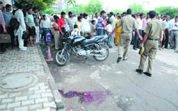 People and police gather at Lado Sarai in South Delhi where a 17-year-old girl was shot