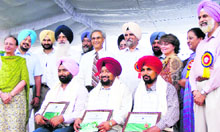 Farmers strike a pose after receiving awards on Thursday.