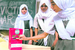 Muslim school girls of Mesco Grade contribute their donations as part of their Zakath (charity) for the victims of the Bihar flood victims inHyderabad