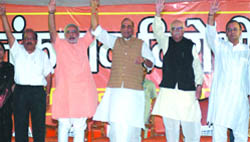 BJP president Rajnath Singh, senior party leader L.K. Advani, Gujarat Chief Minister Narendra Modi and others wave at an anti-terrorism rally 