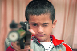 Surya Pratap Singh of AP School, Rohru, takes an aim during a shooting championship at Bishap Cotton School in Shimla 