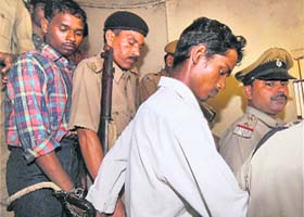 Ramchandra Mahto (in white shirt), the advocate who was found guilty in the Patna University Prof Papiya Ghosh murder case, and one of the other four convicts being taken away after the pronouncement of the verdict in Patna