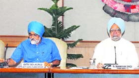 Prime Minister Manmohan Singh with Montek Singh Ahluwalia at the Planning Commission meeting in New Delhi