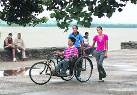 A physically challenged boy being helped by young girls at Sukhna Lake in Chandigarh