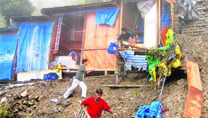 Shopkeepers retrieve their belongings after a landslide swept across the Tibetan Market in Shimla on Saturday.