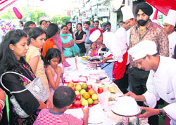 Visitors take a look at a stall of cakes during an exhibition organised by Hot Breads in Sarabha Nagar, Ludhiana