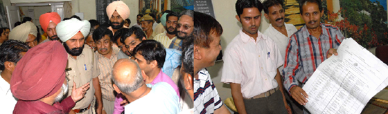 Voters arguing with the polling staff to restart elections for Panjab University senate at the DAV College in Bathinda on Sunday; and right: Polling staff show the invalid ballot papers which were snatched away by some miscreants trying to capture the polling booth in Bathinda on Sunday.