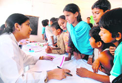 A doctor examines children at the health mela held at Bapu Dham colony in Sector 26, Chandigarh 