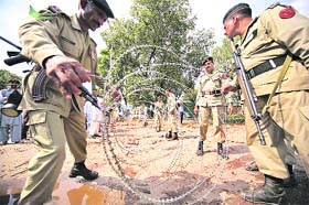 Pakistani paramilitary forces lay barbed wire to cordon off the area near the Marriott Hotel after a suicide bomb blast in Islamabad
