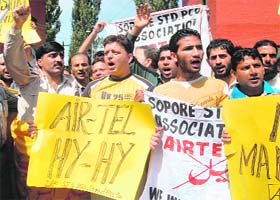 Members of the Jammu and Kashmir STD PCO Association protest in Srinagar on Sunday, asking Airtel to shift its customer care centre back to the summer capital