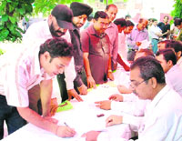 A voter checks his name in the voters list during elections to Panjab University senate at SDP College in Ludhiana on Sunday.