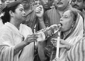 Trinamool Congress chief Mamata Banerjee offers water to Kiswar Jahan, mother of Rizwanur Rahman, during a rally on his first death anniversary in Kolkata