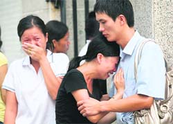 Family members grieve as they identify the bodies of victims of a fire at the Wuwang Club in Shenzhen, in southern China's Guangdong province, on Sunday.