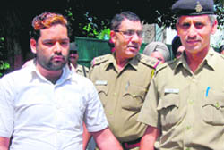 Tantrik Sartaj, co-accused in the case of duping a woman, being taken by the police at the Sector 22 police post in Chandigarh