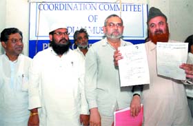 Members of the co-ordination committee of Indian Muslims display the rent agreement papers of house number L-18 in New Delhi 