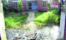 Wild vegetation and stagnant water in compound of panchayat ghar housing subsidiary health centre at Khanpur, native village of Bobby Jindal, Indian-American Governor of Louisiana, exhibit pathetic attitude of administration towards demands of villagers.