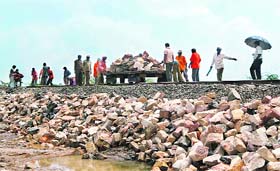 Western Railway workers restore the damaged railway line between Viramgam-Surendranagar section, 120 km from Ahmedabad