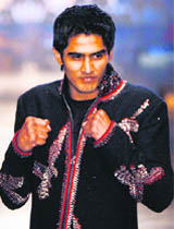 Olympic mens middleweight boxing bronze medallist Vijender Kumar wears a creation by designer Rohit Bal during India Couture week in Mumbai