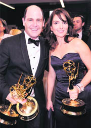 Matthew Weiner holds the awards for outstanding writing for a drama series and outstanding drama series for "Mad Men" as he talks with Tina Fey backstage at the 60th Primetime Emmy Awards on Sunday in Los Angeles.