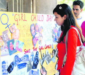 Students at an exhibition held at Students’ Centre, Panjab University, to mark Girl Child Day on Tuesday.