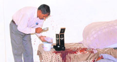 A fingerprint expert examines the crime spot in Arjun Nagar, Gurgaon.