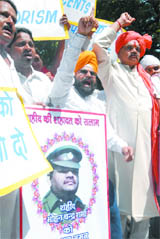People under the banner of United Anti-terrorism Organisation pay tributes to martyr Mohan Chand Sharma and demand a law on terrorism, in New Delhi