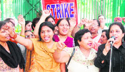 Employees of various public sector banks under the banner of United Forum of Unions shout slogans against the C