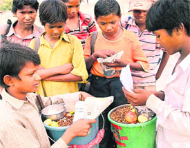 These two children eke out a living by selling eatables when they should rather be attending school.