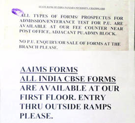 A notice conveying that forms of AIIMS and CBSE are available at the SBI cash counter, PU, while another notice