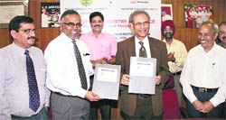 PAU vice-chancellor Dr Manjit Singh Kang and Mahindra and Mahindras chief operating officer Gautam Nagwekar at the signing of MoU in Ludhiana 