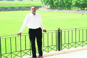 Jaswant Singh, who came up with the idea of a football stadium, stands in front of the pitch