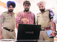 Accused Manoj Kumar identifies his accomplices on the CCTV footage at the Sector 17 police station in Chandigarh on Saturday.