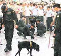 NSG and Delhi police personnel inspect the blast site in a flower market in Mehrauli in South Delhi 