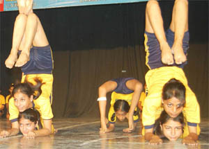 Girls perform yoga during a yoga championship at Shaheed Bhagat Singh Welfare Club at the BBK DAV College for Women in Amritsar on Saturday