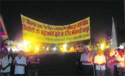 Tibetans take out a candlelight procession in Paonta on Saturday night. 
