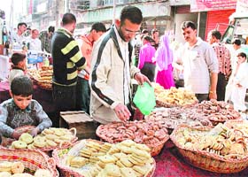 With Eid round the corner, people buy goodies in a Srinagar market