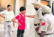 Policemen enquire about abductors location from the boy in Ludhiana on Sunday.