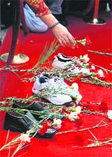 A woman lays a carnation during an anti-gun rally on the Individual Disarmament Day in Istanbul on Sunday.