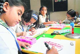 Tiny tots take part in a painting competition on the International Peace Day at Kundan International School, Sector 46, in Chandigarh