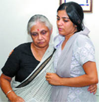 Delhi CM Sheila Dikshit consoles the widow of inspector M.C. Sharma after handing over a cheque of Rs 11 lakh to her in New Delhi 