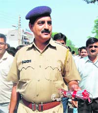A police officer shows a bomb-like object found in front of Banke Bihari Temple in Faridabad