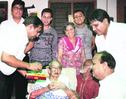 Yash Pal Sharmas mother Sandhya Devi being congratulated by cricket lovers at her residence in Ludhiana. 