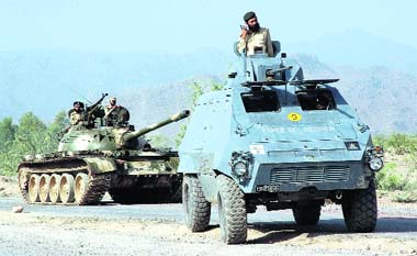 ON GUARD: Pakistani army soldiers patrol a street during a military operation against militants in Darra Adam Kheil on Monday. Pakistani security forces have launched a major offensive against the militants in Darra and several other tribal areas to combat rising militancy in the northwest