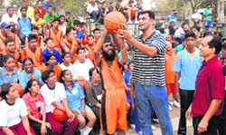 Former international basketball player Jaldeep Dhaliwal gives tips to special children during a national camp at Sports Complex in Chandigarh 