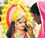 An artist puts the finishing touches to an idol of Goddess Durga in Gurgaon