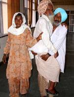 Joginder Singh, an aged farmer, being brought out of the office of the deputy commissioner on Wednesday, after complaining against the patwari who was pressurising him to sell him his agricultural land to him. 