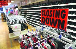 A sign warning of a store closure is pictured in a shoe shop in Guildford, in south-east England